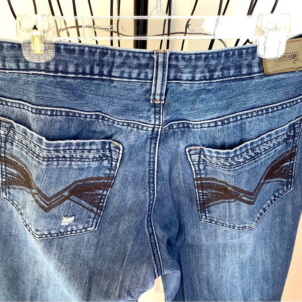 Men’s jeans with a few distressed rips for style but not many